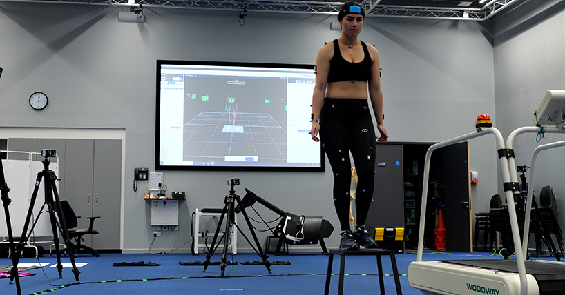 A woman testing leggings with monitors on her body and legs